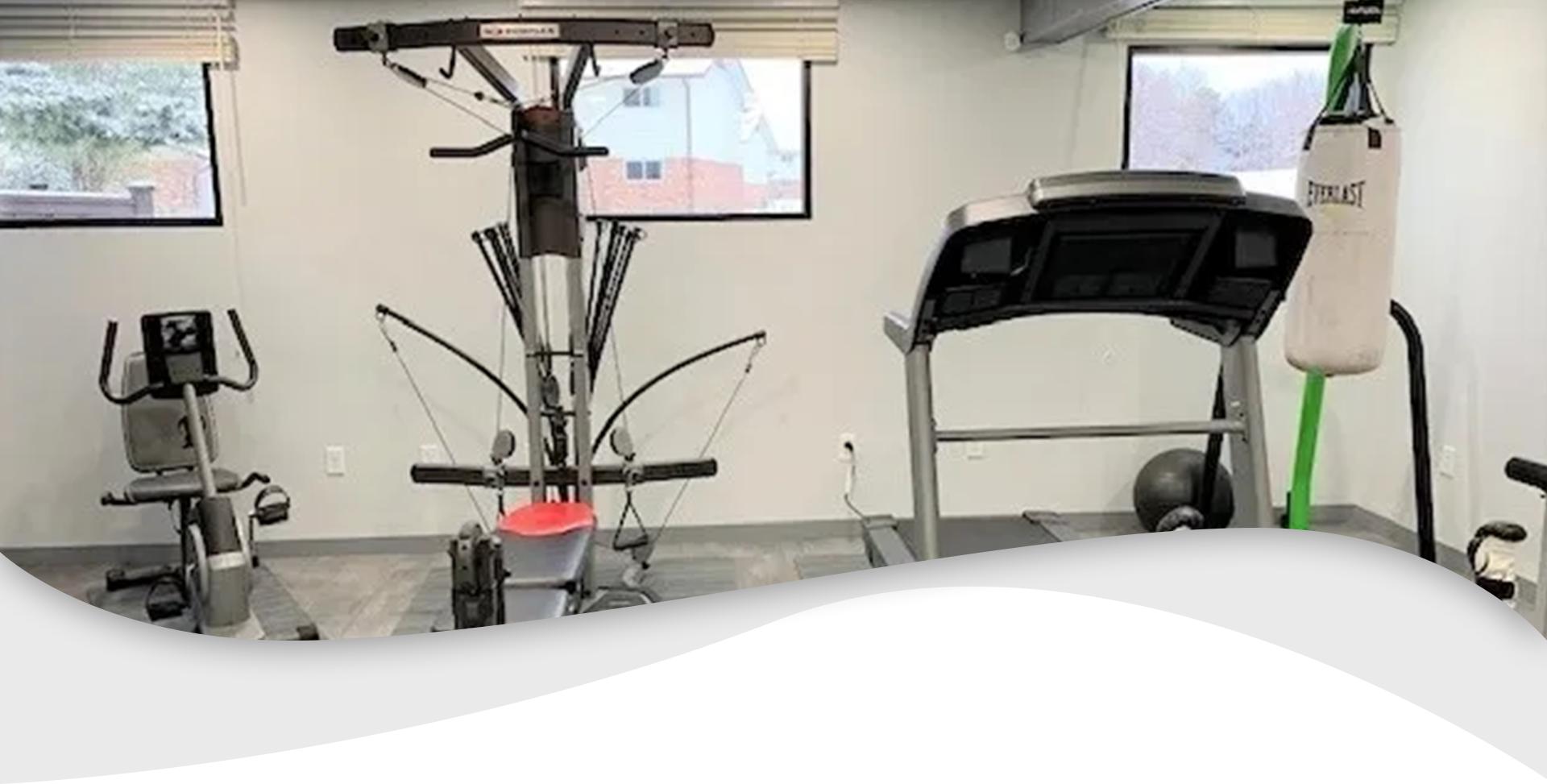 A gym with a green floor and a large screen