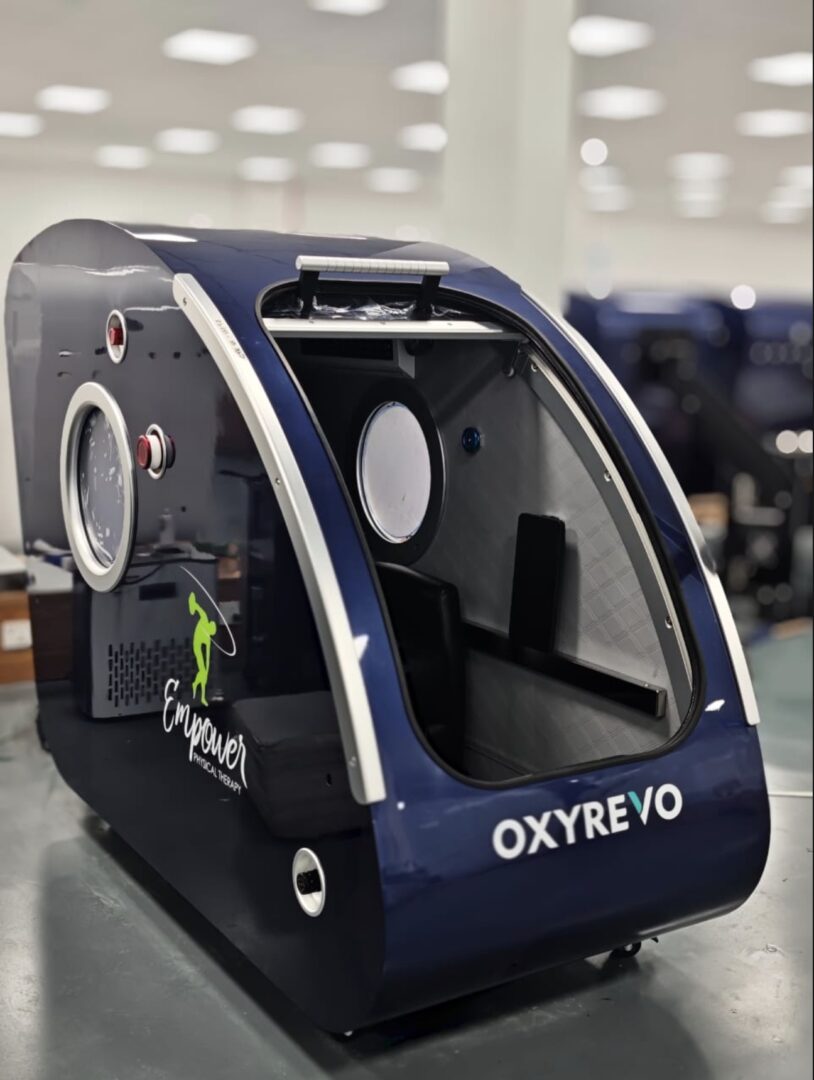 Blue hyperbaric chamber on display table.